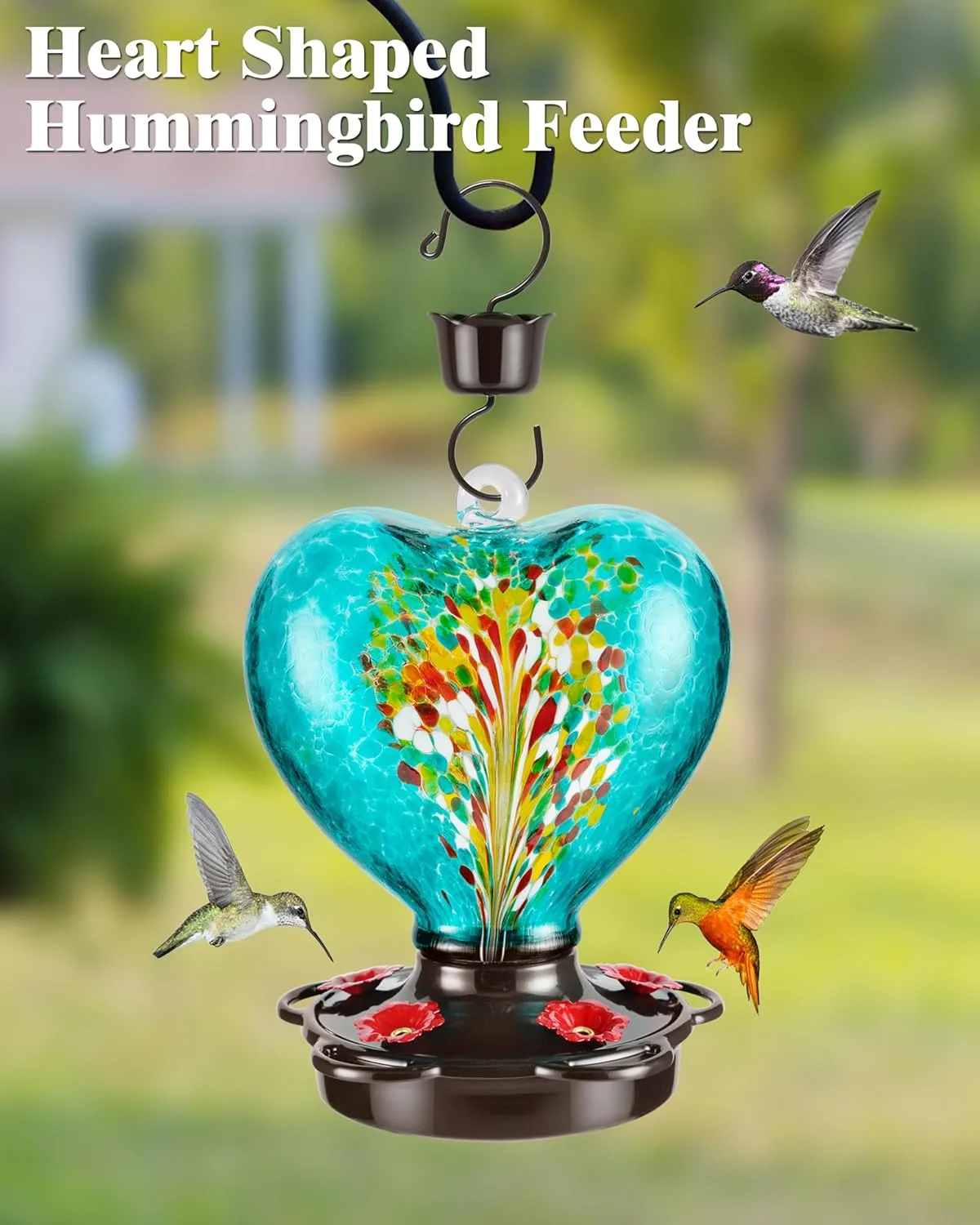 Teal heart-shaped hummingbird feeder hanging outdoors, showcasing vibrant glass colors and Phoenix tail design. Leak-proof and rustproof with built-in ant moat. Perfect for attracting hummingbirds to gardens, patios, and outdoor spaces